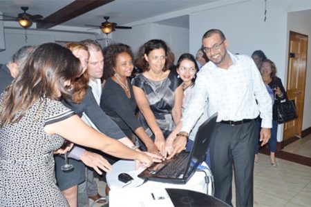 Minister of Natural Resources and the Environment, Robert Persaud (right) and United Nations Resident Representative to Guyana, Khadija Musa (fourth from right) and representatives of other countries press the button to launch the Guiana Shield Priority Setting Platform. (GINA photo)