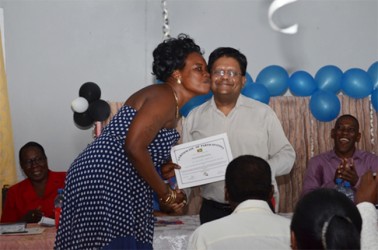 A very happy participant receiving her certificate from Finance Minister, Dr. Ashni Singh at the Basic Needs Trust Funds (BNTF), Beterverwagting ICT graduation ceremony. (GINA photo)