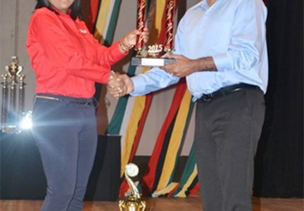 A Digicel Representative receives the award for the National Full Costume large winner from Minister of Culture, Youth and Sport, Dr Frank Anthony (GINA photo)