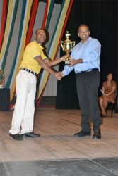 Chutney Monarch Young Bill Rogers receiving his award from Culture Minister Dr Frank Anthony (GINA photo)
