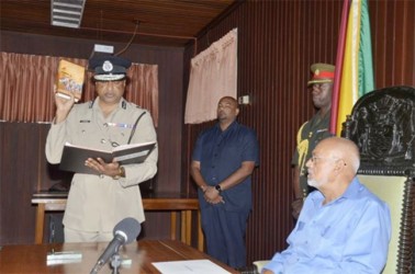 Police Commissioner Seelall Persaud taking his oath of office before President Donald Ramotar (GINA photo)