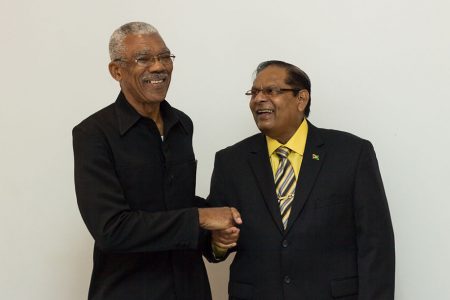 APNU+AFC Presidential candidate David Granger (left) and Prime Ministerial candidate Moses Nagamootoo shake hands at the formal launch of the alliance today at the Guyana Pegasus.  (APNU+AFC photo)