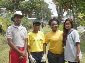 Guyana Shines project members and a Republic Bank representative taking a break from their clean-up campaign on Waterloo Street last Sunday. In the photo, from left to right are Dexter Gonsalves, Crysteline Younge, Trishtana DeCunha and Sabita Lall. (Rae Wiltshire photo) 
