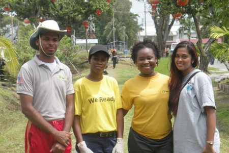 Guyana Shines project members and a Republic Bank representative taking a break from their clean-up campaign on Waterloo Street last Sunday. In the photo, from left to right are Dexter Gonsalves, Crysteline Younge, Trishtana DeCunha and Sabita Lall. (Rae Wiltshire photo) 
