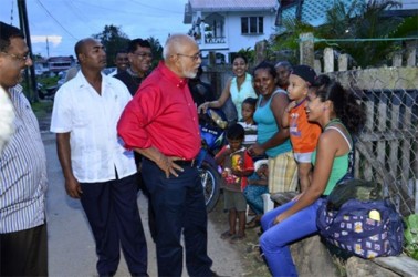 President Donald Ramotar (centre) sharing a light moment with a group of residents in Rose Hall, Berbice (GINA photo)