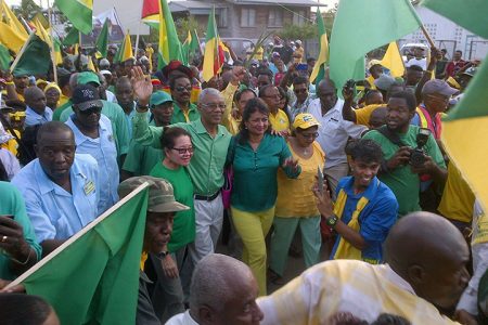 APNU+AFC Presidential candidate David Granger being welcomed at Whim, Corentyne this afternoon for the opposition alliance’s rally. He is flanked by his wife Sandra (left) and APNU member Supriya Singh.