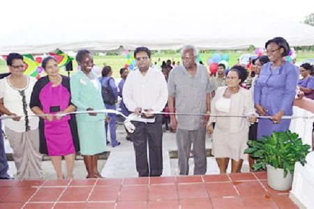 Minister of Finance, Dr Ashni Singh (centre), General Manager of the National Insurance Scheme, Doreen Nelson (third from left) and former General Manager Patrick Martinborough (third from right) during the cutting of the ribbon to commission the complex (GINA photo)
