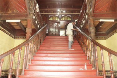 A worker painting the stairway leading to the Council Chamber from the Avenue of Republic entrance of City Hall 