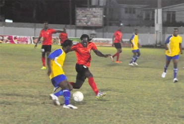 Pele forward Omallo Williams trying to skip past Alpha United’s left-back Abassi McPherson during semi-final action between the two clubs in the Kashif and Shanghai tourney