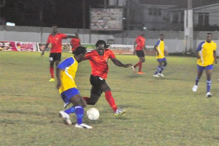 Pele forward Omallo Williams trying to skip past Alpha United’s left-back Abassi McPherson during semi-final action between the two clubs in the Kashif and Shanghai tourney