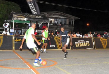 Kester Greene of Plaisance-A in the process of attempting a pass while being challenged by BV-A’s Delroy Dean (center) during their semi-final affair