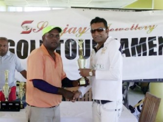 FLASHBACK! Mahendra Bhagwandin current title holder receiving his trophy last October from Sanjay’s Jewellery’s Sanjay Persaud.