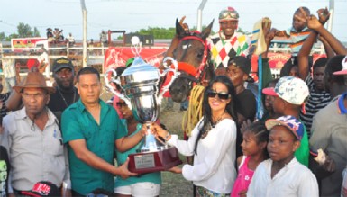 Handlers of CP Got Even accepting the winner’s trophy for yesterday’s feature A and Lower Event. (Orlando Charles photo)