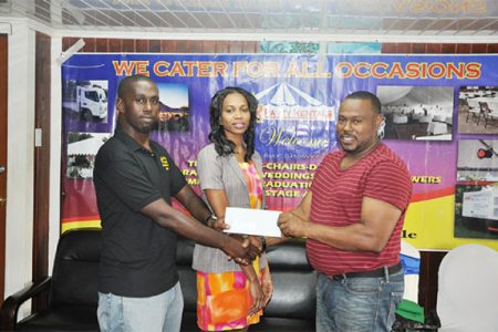 Petra Organization Co-Director (right) collecting the sponsorship cheque from Star Party Rental representative Robert Joseph (left) while fellow company employee Kesheke Washington looks on.