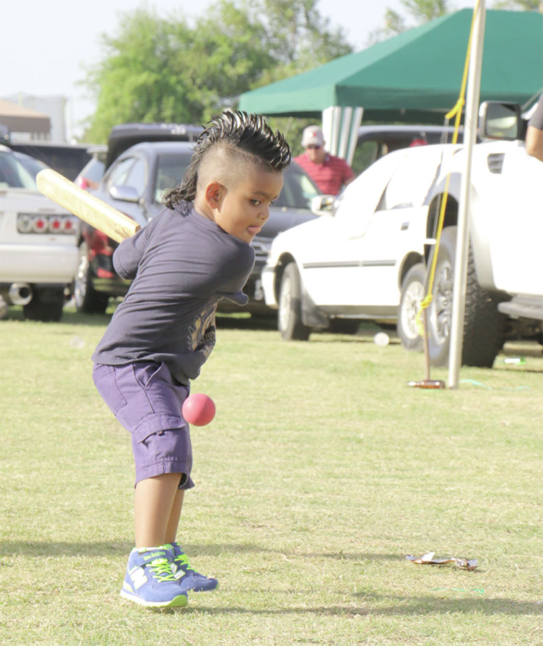 This lad with the Sunil Narine hairstyle lines up a shot - Stabroek News