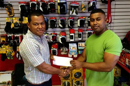 Organizing Secretary of the GABBFF, Videsh Sookram (right) receiving the sponsorship cheque from Fitness Express’ manager Ian Rogers yesterday at the company’s 47 John and Sheriff Streets location.
