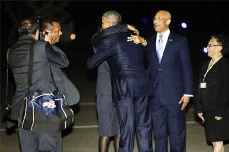U.S. President Barack Obama (C, back to camera) gets a hug from Jamaica's Prime Minister Portia Simpson Miller as he arrives aboard Air Force One at Norman Manley International Airport in Kingston, Jamaica April 8, 2015.
Reuters/Jonathan Ernst