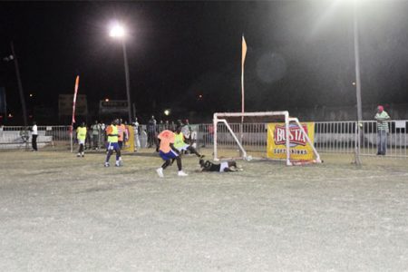 Rafael Edwards (orange) of Tucville in the process of scoring his side’s third goal, equalizing the matchup against Leopold Street during the second match of the night.
