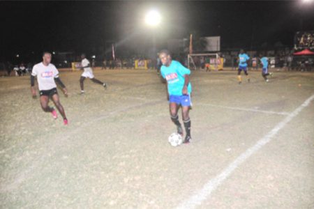 Calvin Shepherd of Holmes Street Tiger Bay on the attack down the left flank while being pursued by Shaka Jones of Albouystown during the two teams’ matchup.
