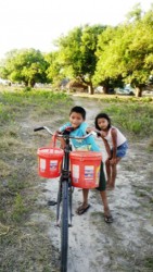 A child and his sister using a bicycle to fetch water to their home in Karaudarnau yesterday. Drought is affecting the Deep South Rupununi community