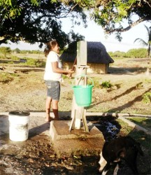 A resident operates the lone pump in the centre of the Karaudarnau village that provides water to residents. 