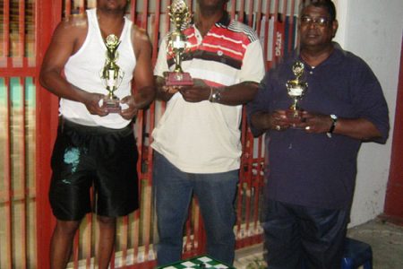 Winner of the Guyana Draughts Association A Class event Floyd Cumberbatch is flanked by Khemraj Pooranmall, left and Jairam Ramdeen, the second and third place finishers respectively.