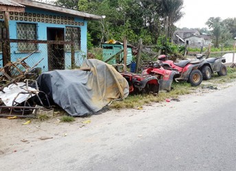 No longer in service: Abandoned ATVs outside a mechanic shop in Bartica. 