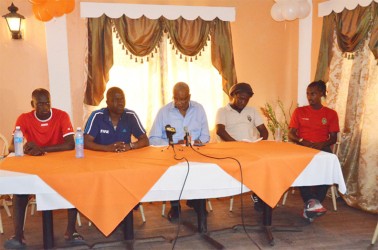 Inter Moengotapoe Communications Officer Humphrey Dundas (2nd from left) speaking to the gathering while Inter Moengotapoe defender Jermin Vallei (left), Alpha United President Odinga Lumumba (centre), Head-Coach Wayne Dover (2nd right) and Gregory Richardson (right) looks on  