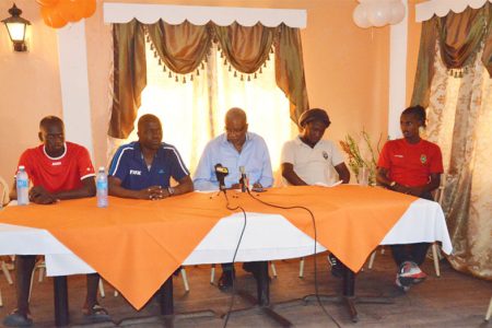 Inter Moengotapoe Communications Officer Humphrey Dundas (2nd from left) speaking to the gathering while Inter Moengotapoe defender Jermin Vallei (left), Alpha United President Odinga Lumumba (centre), Head-Coach Wayne Dover (2nd right) and Gregory Richardson (right) looks on
