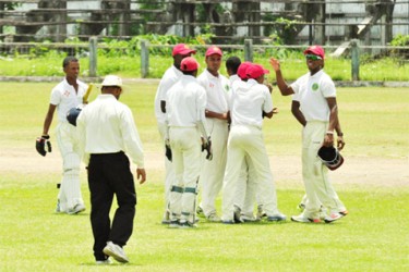 Century maker Shimron Hetmyer (with shades on) is congratulated by his teammates following their crushing 216 run win over Demerara yesterday. (Orlando Charles photo) 