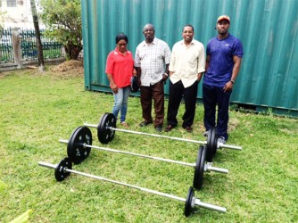 The top brass of the GWA pose for a photo with some of the equipment received on the lawns of the GOA. From left is Subrina Pestano (Vice President), Frank Tucker (President), Seon Erskine (General Secretary) and Aubrey Henry (Public Relations Officer). 