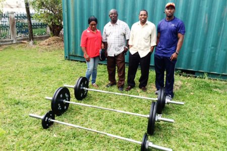 The top brass of the GWA pose for a photo with some of the equipment received on the lawns of the GOA. From left is Subrina Pestano (Vice President), Frank Tucker (President), Seon Erskine (General Secretary) and Aubrey Henry (Public Relations Officer).
