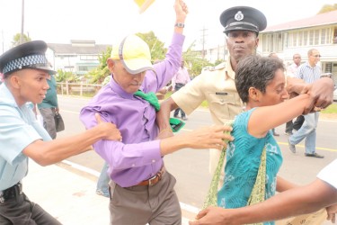 The police had a hard time controlling APNU+AFC candidate Ronald Bulkan and rights activist Sherlina Nageer as they sought to protest outside of the Marriott Hotel yesterday.  