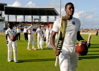 Jason Holder leads the way off the field on the final day of the first Test between West Indies and England yesterday at the Vivian Richards Cricket Ground. Photo by WICB Media/Randy Brooks of Brooks Latouche Photography 