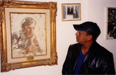 Sunday Stabroek chess columnist Errol Tiwari gazes admiringly at a painting of Bobby Fischer in the Manhattan Chess Club. It was the closest I could get to the great man. For over a decade or even longer, Fischer, like another American original, Muhammed Ali, had boasted that he was the greatest. Fischer told the world that the Russians had his title and that he wanted it back. People were amused. There was tolerant laughter. Imagine a brash 28-year-old chess upstart from Brooklyn challenging the awesome Soviet chess machine at their own game! But still the whole world, not only the chess world, was eager to see if he could beat the Russians, especially such a formidable opponent as Boris Spassky. Well he did; and the world fell in love with him.
