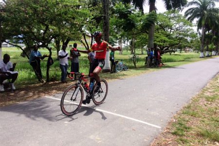 Team Coco’s Jamal John crosses the finish line unchallenged to take the spoils of the 11th annual United Auto and General Supplies criterium programme yesterday at the National Park.