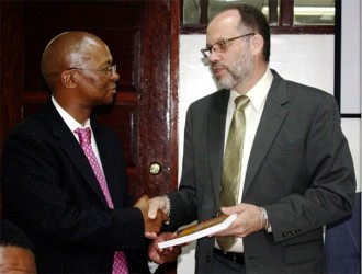 CARICOM Secretary-General, Irwin LaRocque (right) presents a copy of the Revised Treaty of Chaguaramas to Baso Sanqu, Chief Adviser to the Chairperson of the African Union Commission during a courtesy call at the CARICOM Secretariat on Thursday 