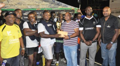 The Victorious Manchester Boys receiving the championship trophy and first prize following the conclusion of the finale while Guinness Brand Manager Lee Baptiste (2nd from right), Outdoor Events Manager Gavin Jodhan (right) and Communicat-ions Manager Troy Peters (right) looks on.