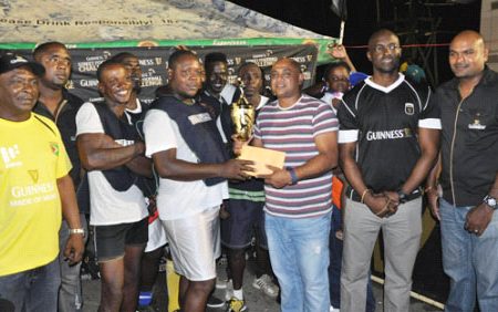 The Victorious Manchester Boys receiving the championship trophy and first prize following the conclusion of the finale while Guinness Brand Manager Lee Baptiste (2nd from right), Outdoor Events Manager Gavin Jodhan (right) and Communicat-ions Manager Troy Peters (right) looks on.
