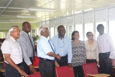 Sattaur Gafoor (third from left)  makes the presentation to UG Vice Chancellor Jacob Opadeyi. Ameena Gafoor is third from right while Joshua Griffith is at right. 