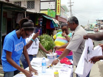 A passer-by taking the time to participate in the mock voting exercise