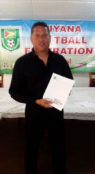 GFF Technical Director Claude Bolton displaying the newly created ‘Next Generation Project’ developmental manifesto following the end of the press conference