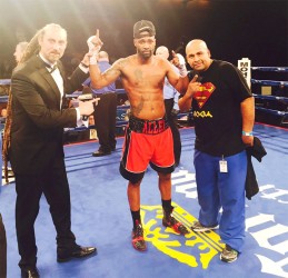 Lennox Allen poses for a photo in the ring following his win on Friday night. 