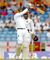 Marlon Samuels celebrates reaching his seventh test ton on day   two of the second Test between  the West Indies  and  England at Grenada National Cricket Stadium, St. George’s, Grenada  yesterday.  Photo by WICB Media/Randy Brooks of Brooks Latouche Photography