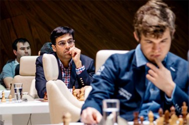 Two famous world chess champions, one current, Magnus Carlsen, and the other former, Vishy Anand, are photographed together at the celebrated Vugar Gashimov Memorial Tournament in Shamkir, Azerbaijan. Carlsen and Anand drew their individual game which is always an anticipated encounter since the two squared off last year for the world championship title. After five rounds Carlsen is leading the tournament while Anand is in an unruffled third place. Carlsen replaced the American Wesley So as the leader of the competition while Anand engineered a brutal concept in the Spanish Ruy Lopez to overcome So. In the photo does Anand seem to be concentrating on Carlsen rather than his opponent?
