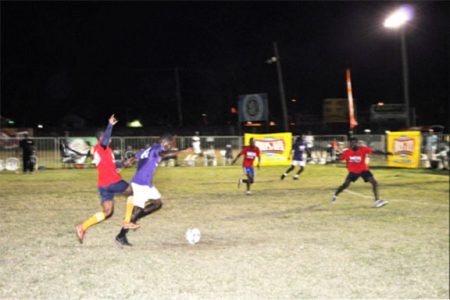 Jamal Pedro (right) of West Front Road being battling to keep possession of the ball while being challenged by several North East La Penitence players during their round of 16 fixture