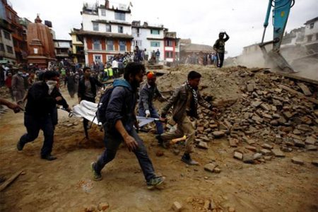People carry the body of a victim on a stretcher, who was trapped in the debris after an earthquake hit, in Kathmandu, Nepal April 25, 2015.(Reuters/Navesh Chitrakar)