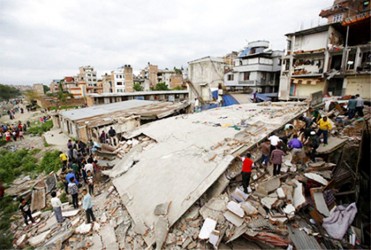 People gather near a collapsed house after a major earthquake in Kathmandu, April 25, 2015. REUTERS/Navesh Chitrakar