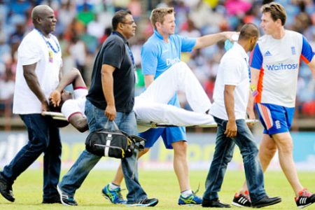 Jason Holder being carried off on a stretcher during Saturday’s play. (Photo courtesy of WICB media)