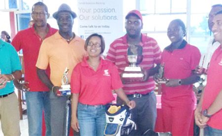 The winners and three Scotiabank representatives, left to right, I. Gouveia, Country Manager – Raymond Smith, Dr Philbert London, Jennifer Cipriani, Mahendra Bhagwandin, Shanella Webster, P. Prashad (partly hidden) and Parmeshwar Budhu.